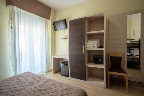 A bed or beds in a room at Hotel Bamby