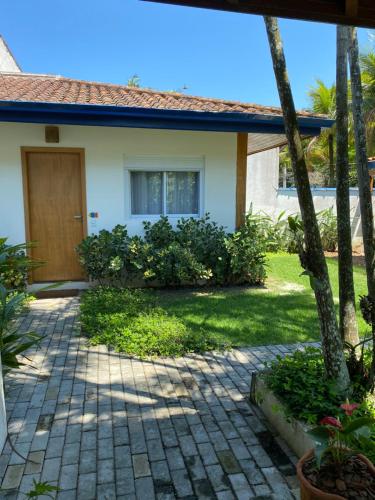 a house with a door and a patio at Ao Mar - Hospedagem in São Sebastião