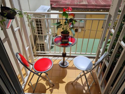 a balcony with a table and two chairs and a plant at Costa del Sole in Salerno