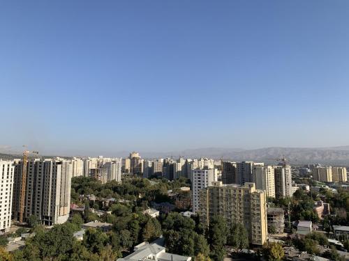 an aerial view of a city with tall buildings at Hotel Panorama in Dushanbe