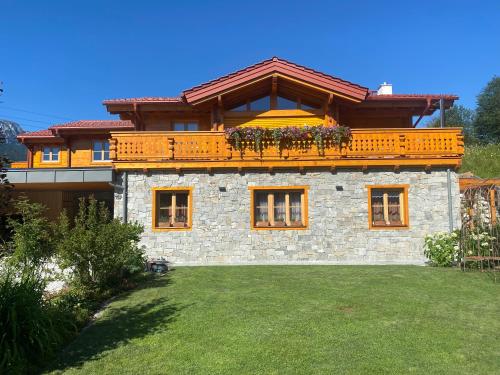 a large house with a balcony on top of it at Chalet Alma in Haus im Ennstal