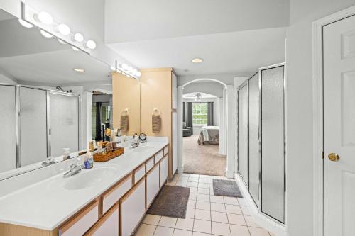 a bathroom with two sinks and a large mirror at Condo in Lakefront Resort with Boat Launch and Pool! in Kimberling City
