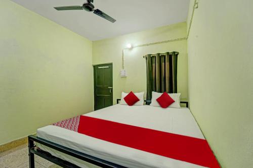 a bedroom with a large bed with red pillows at Flagship The Moon Palace in Patna
