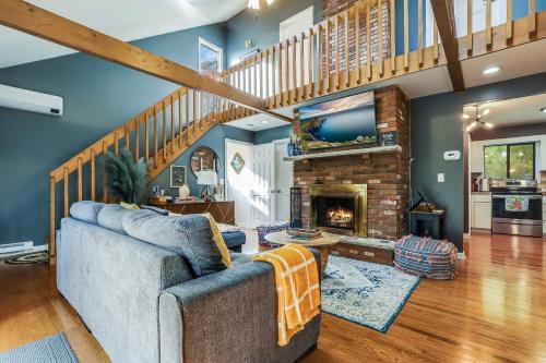 a living room with a couch and a fireplace at Hot Tub, Fire Pit and Barrel Sauna Poconos Abode in Long Pond