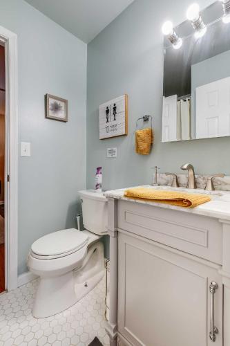 a white bathroom with a toilet and a sink at Hot Tub, Fire Pit and Barrel Sauna Poconos Abode in Long Pond