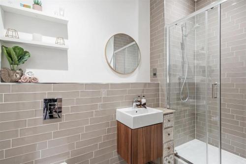 a bathroom with a sink and a shower at Solihull Town Centre Spacious Studio Apartment in Solihull