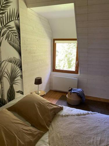 a bedroom with a large bed and a window at Appartement en campagne in Berville-sur-Mer