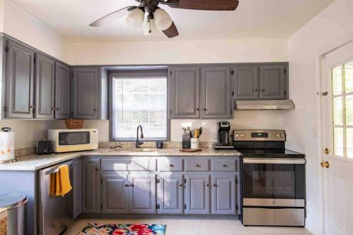 a kitchen with gray cabinets and a ceiling fan at Birmingham Home/2BR/Close to everything! in Birmingham