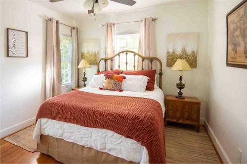 a bedroom with a bed with a red and white comforter at Birmingham Home/2BR/Close to everything! in Birmingham