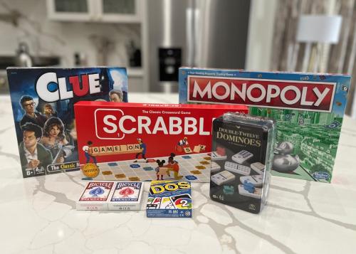 a group of games and books on a table at Luxury (Less than mile from AT&T Stadium/GlobeLife) GameRoom/Basketball Hoop in Arlington