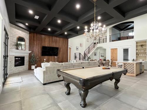 a living room with a pool table in it at Luxury (Less than mile from AT&T Stadium/GlobeLife) GameRoom/Basketball Hoop in Arlington