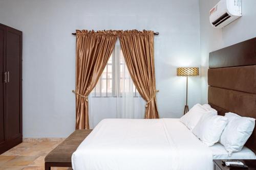 a bedroom with a large bed and a window at IKOGOSI WARM SPRINGS RESORT in Ikogosi