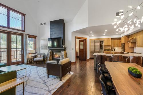 a kitchen and living room with a table and a fireplace at Penthouse in One Ski Hill in Breckenridge