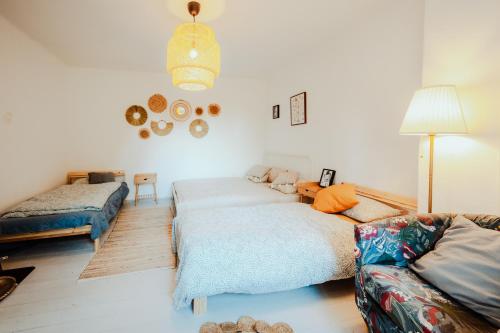 ein Wohnzimmer mit einem Bett und einem Sofa in der Unterkunft Country house Harmonia in Modra