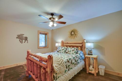 a bedroom with a wooden bed and a ceiling fan at Cozy Alma Mountain Retreat Fireplace and Grill in Alma