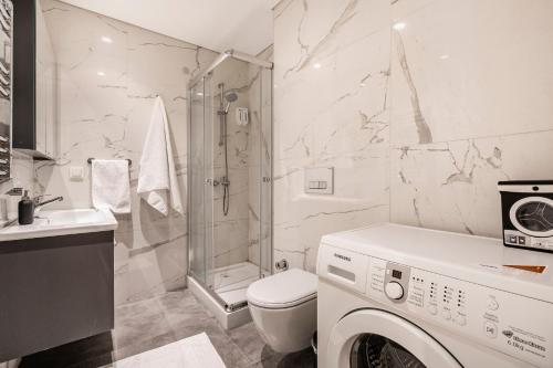 a white bathroom with a washing machine in it at Seba Suites Central Istanbul in Istanbul