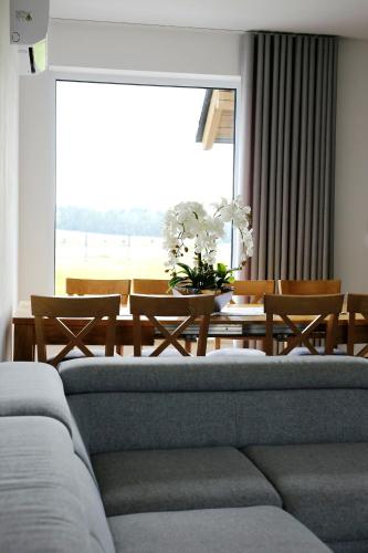 a living room with a couch and a table with chairs at Zakątek Relaksu in Kamienica Królewska