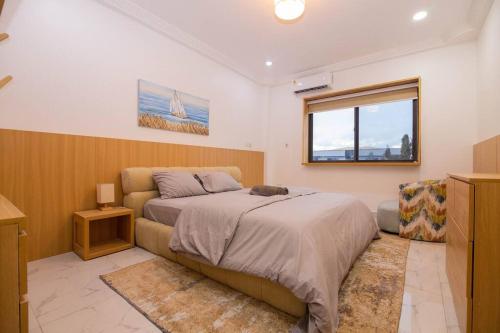 a bedroom with a bed and a window at Big chill stays East Legon in Accra