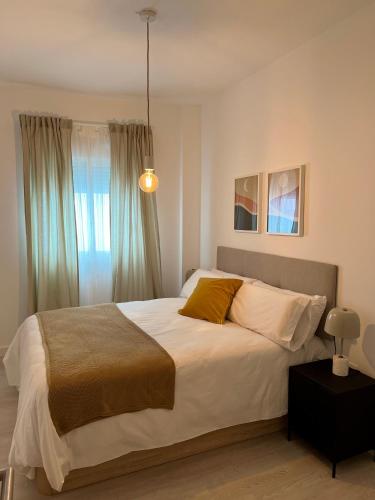 una camera con un grande letto e una finestra di Amazing Apartment City Center - Optional parking a Málaga