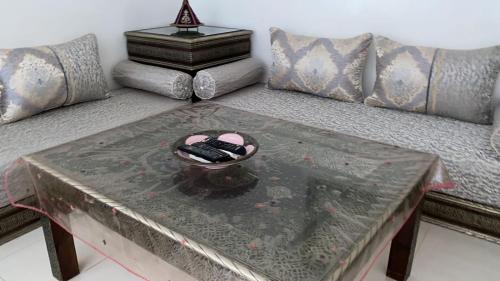 a table with two remote controls on top of a couch at Riad lalla aicha in Marrakech