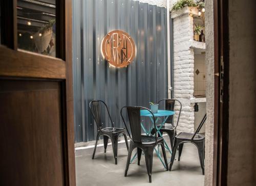 a table and chairs in front of a door at MedioMundo Hostel in Montevideo
