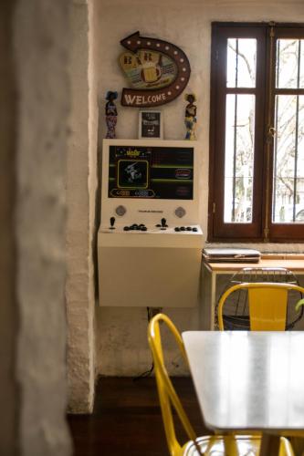 a kitchen with a table and a television on a wall at MedioMundo Hostel in Montevideo