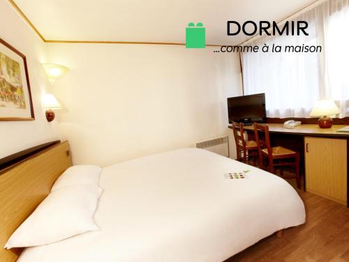 a bedroom with a bed and a desk with a computer at Campanile Marmande in Marmande