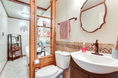 a bathroom with a sink and a toilet and a mirror at Ranch Getaway with Pool and Horse Stall Access! in Calera