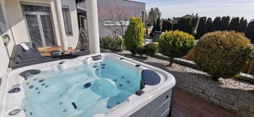 a jacuzzi tub in the backyard of a house at Casa M in Lopatinec