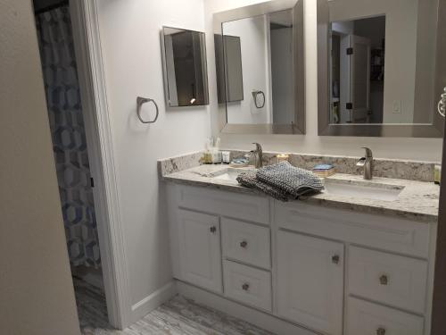 a bathroom with a sink and a mirror at LUX VILLAs on beautiful Palmer Ranch in Vamo