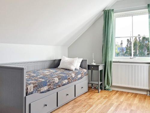 a bedroom with a bed and a window at 8 person holiday home in LÖTTORP-By Traum in Löttorp