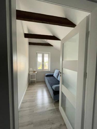 a living room with a couch and a window at Apartament przy Teatrze in Chorzów