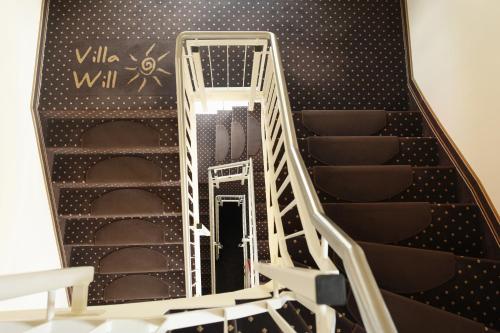 an open stair case with a ladder in a room at Hotel Villa Will in Hannover