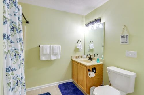 a bathroom with a toilet and a sink and a shower at Spacious Murphy Home with Game Room and Fire Pit! in Murphy