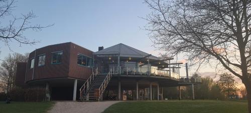 a large brick house with a balcony and stairs at Sientjes Boetiekhotel in Kerkdriel