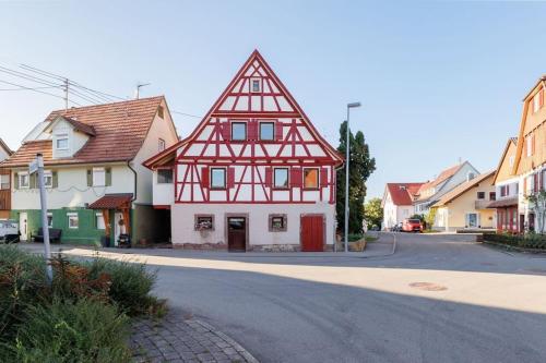 a red and white building on the side of a street at Haugstetter Schwarzwaldhaus in Neubulach