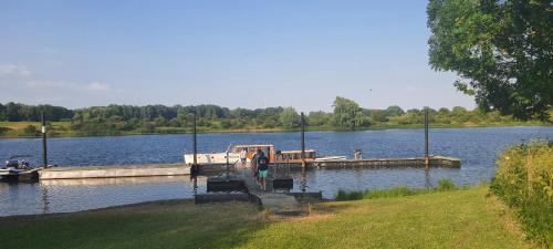 a person standing at a dock on a lake at Sientjes Boetiekhotel in Kerkdriel