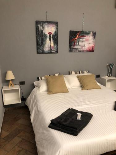 a bedroom with a bed with a black towel on it at IL SALICE in Novara