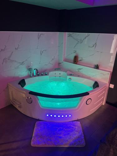 貝爾熱拉克的住宿－Chill & Love Bergerac，浴室配有带紫色照明的大浴缸