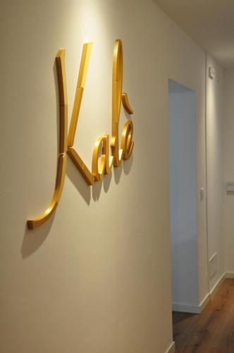 a museum exhibit with a halo sign on a wall at Kalé in Pordenone