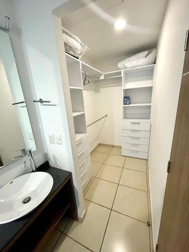 a bathroom with a sink and a mirror at 3 Bed sheets with pool and Gym in "Uno Urban Life in Guadalajara