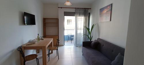 a living room with a couch and a table at North Bay Apartments in Rhodes Town