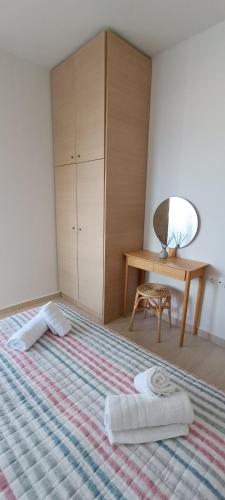 a bedroom with a bed with two towels on it at North Bay Apartments in Rhodes Town