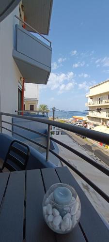 a bowl of shells sitting on a table on a balcony at North Bay Apartments in Rhodes Town