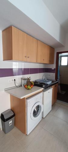 a kitchen with a washing machine and a dishwasher at North Bay Apartments in Rhodes Town