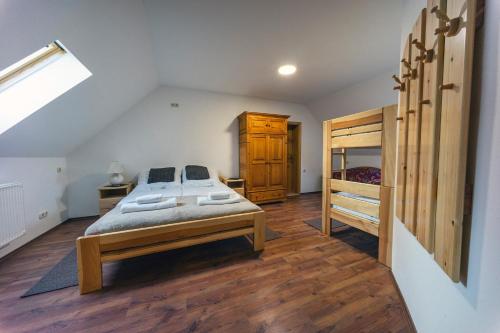 a bedroom with a bed and a wooden floor at Nosztalgiavendégház Zalaháshágy in Zalaháshágy