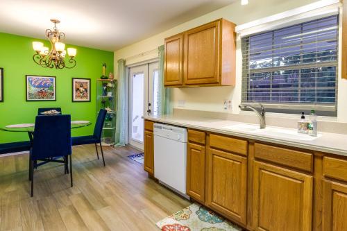 a kitchen with green walls and a table and a sink at Orlando Home with Private Pool 10 Mi to UCF Campus! in Orlando