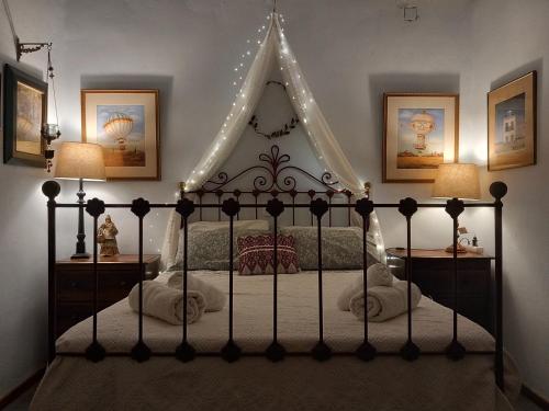 a bedroom with a canopy bed with lights at Aphrodite's Coast Retreat House! in Galaxidhion