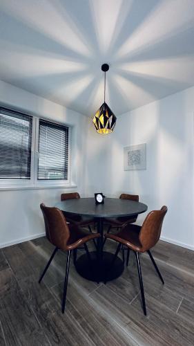 a dining room with a black table and chairs at NewEra Apartment 1 