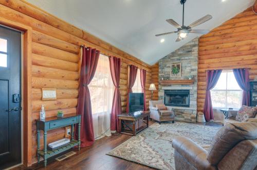 a living room with a fireplace and wooden walls at The Cliffrose Cabin - Hike, Relax, Explore! in Kanab